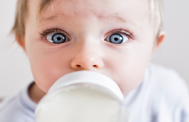baby drinking from milk bottle 