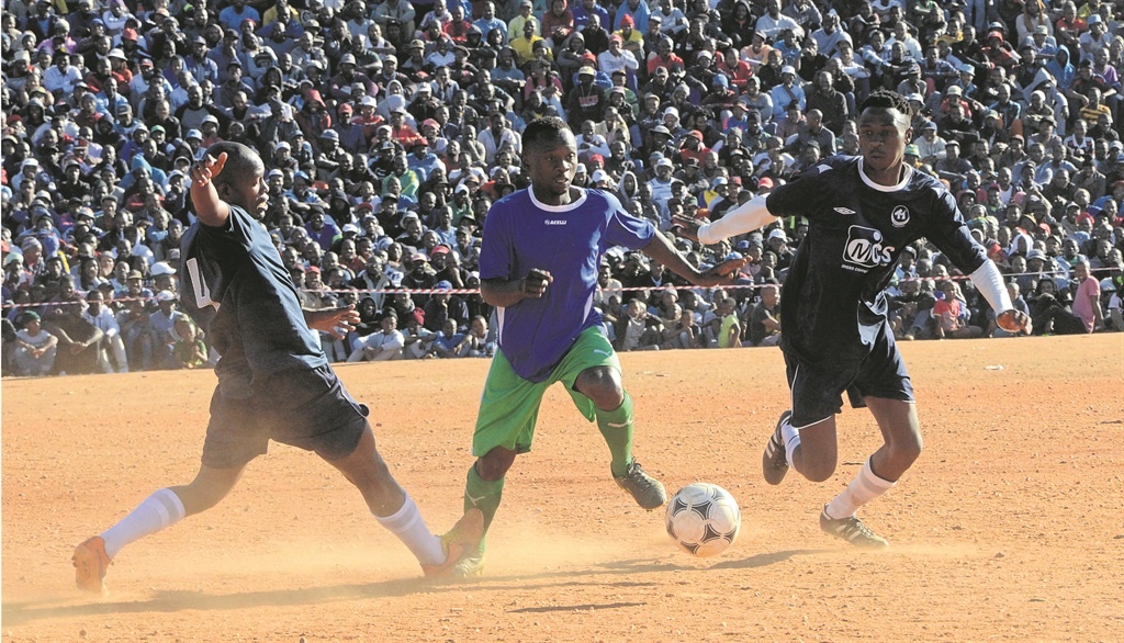 THOUSANDS WATCH: Sphamandla Zwane of Mighty Birds sandwiched by two Braamfisher Eagles players during the annual Maimane Alfred Phiri Games on Sunday. Photo by Bomba Chauke