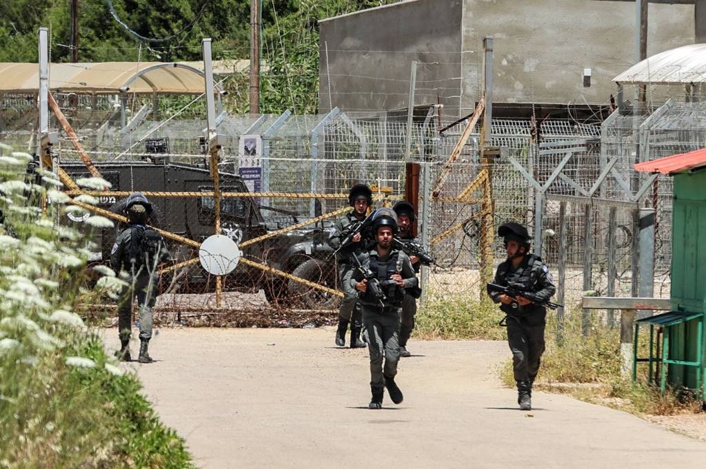 Israeli security forces members on alert at the entrance of the Salem base near the West Bank town of Jenin, following an attack on 7 May 2021.