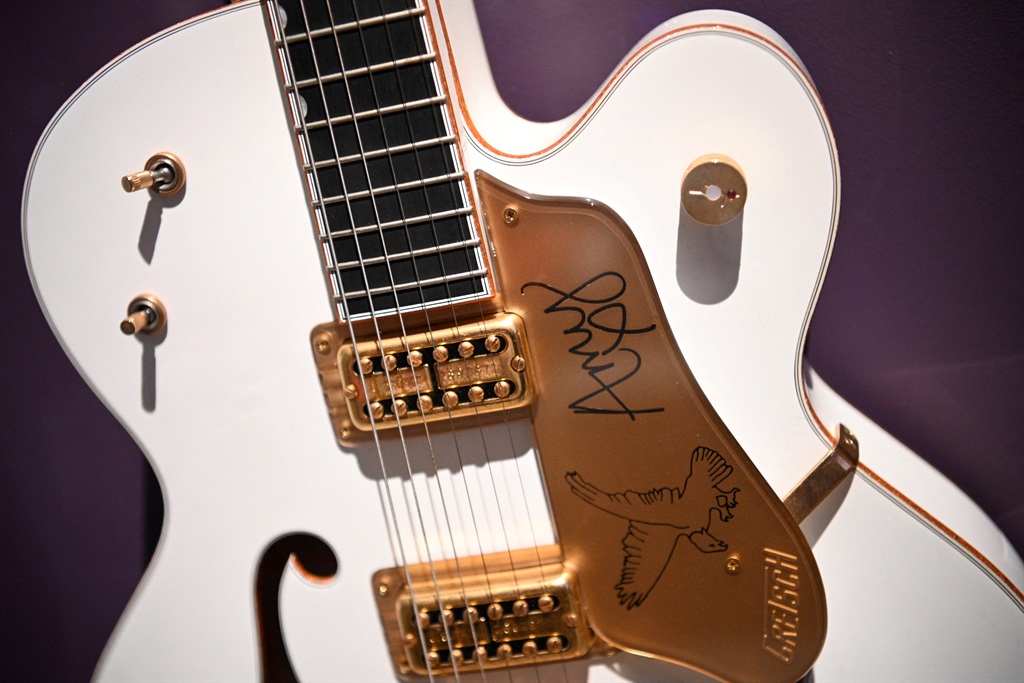 A guitar signed by late British singer Amy Winehou