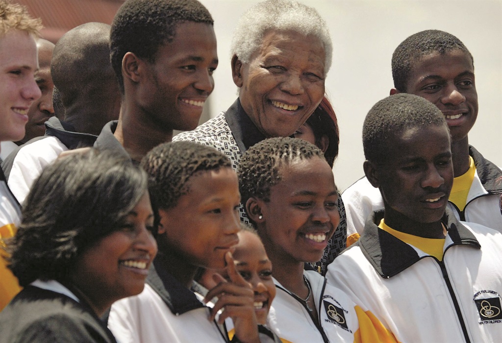 South Africa's former president Nelson Mandela (C) poses for a photograph with members of the Children's Parliament in Midrand, South Africa, on Monday 3 November 2003. Picture:  EPA/Jon Hrusa 