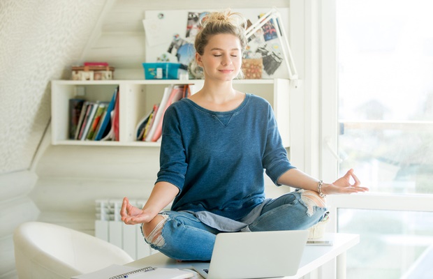 woman meditating on desk 