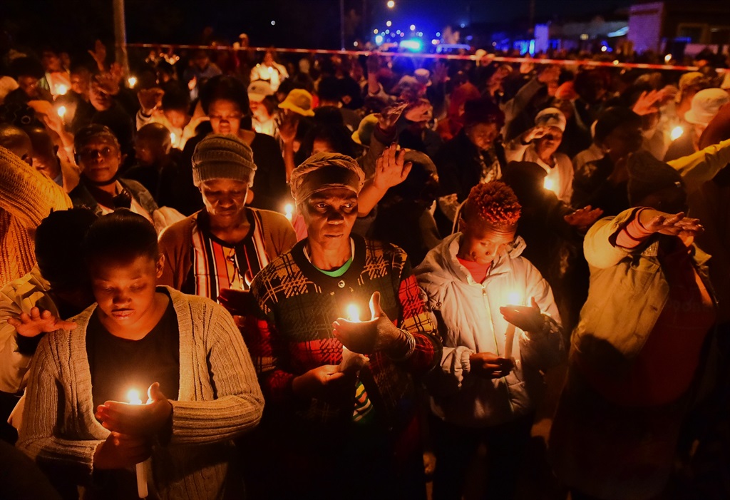 Soweto residents held a candlelight ceremony to pray and comfort the families of Nqobizitha Zulu and Tshiamo Rabanye who were killed.                                   Photo by Morapedi Mashashe