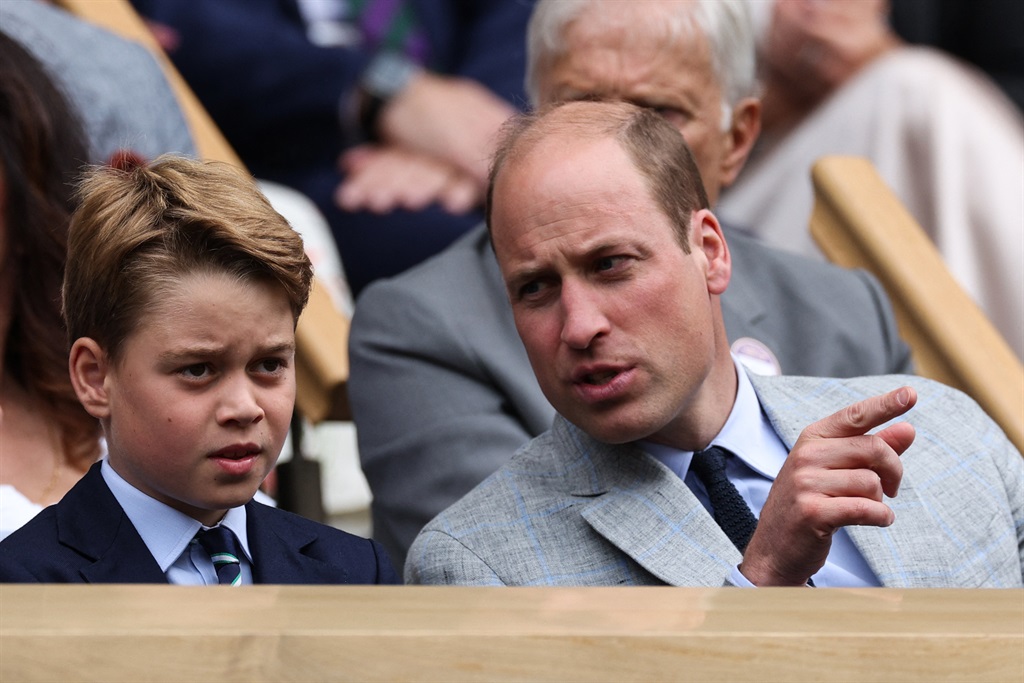 Britain's William, Prince of Wales (R) talks to hi