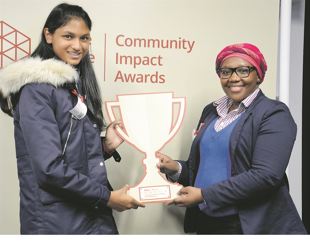 Kiara Nirghin receives the 2016 Community Impact Award from Sci-Bono chief operating officer Tebogo Gule at Google’s offices.                      Photo by Zamokuhle Mdluli 