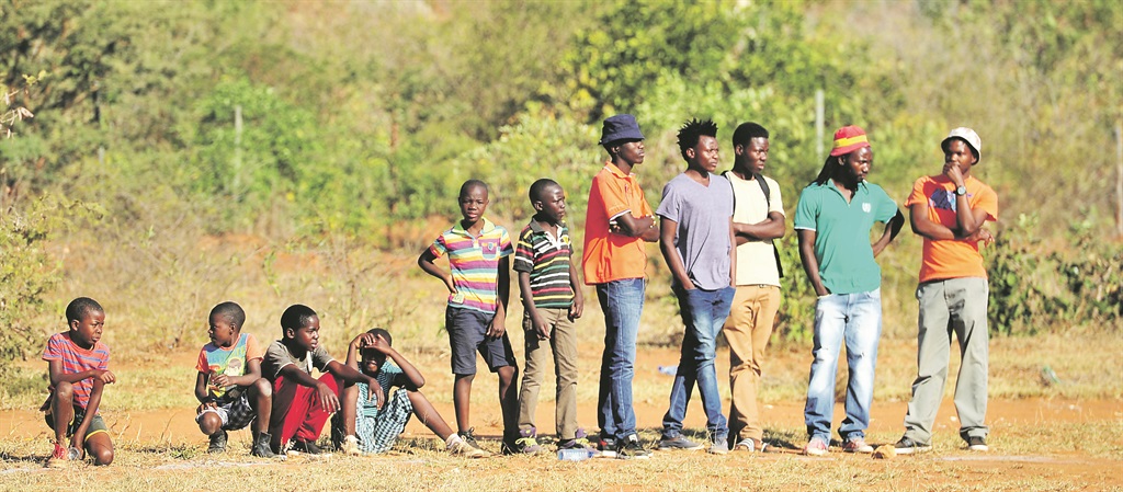 PASSIVE Residents of Vuwani watch a football game instead of making their mark. Picture: Leon Sadiki 