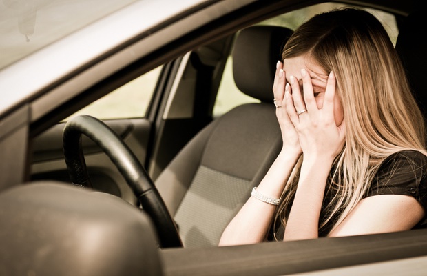 woman having panic attack in car 