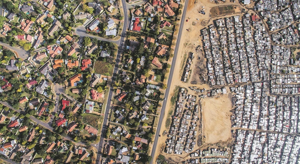Kya Sands in Johannesburg is a story of broken promises. One street separates an informal settlement from the middle class suburb of Bloubosrand. Picture: Johnny  Miller 