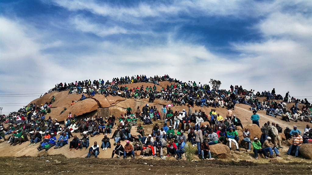 A group of workers of Marikana's Lonmin mine gather at the koppie in remembrance of the killing of 34 miners by the police at the sight. Picture: Tebogo Letsie