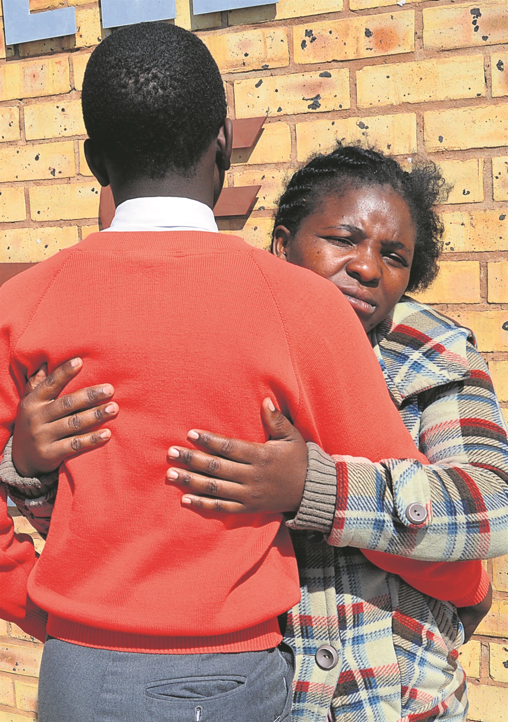 Dineo Mofokeng comforts her son who was allegedly assaulted by a teacher at school.       Photo by Everson Luhanga  