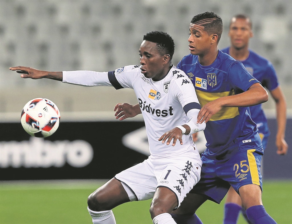 Bidvest Wits’ Elias Pelembe battles with Duncan Adonis of Cape Town City in their MTN8 match.  Photo by Gallo Images 
