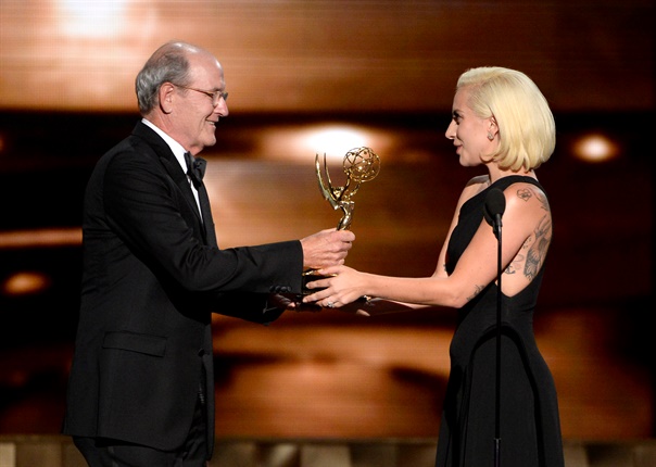 <p>Lady Gaga hands over the Emmy award to Richard Jenkins.</p><p></p>