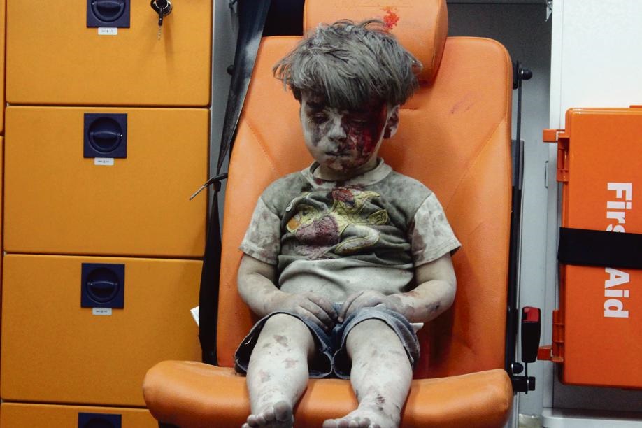 Omran Daqneesh (5) after he was rescued following an airstrike in Aleppo. Picture: Mahmoud Raslan/Reuters 