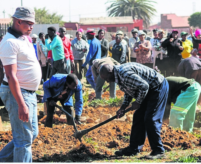 Residents dug up graves behind the local police station.  Photo by Sifiso Jimta 