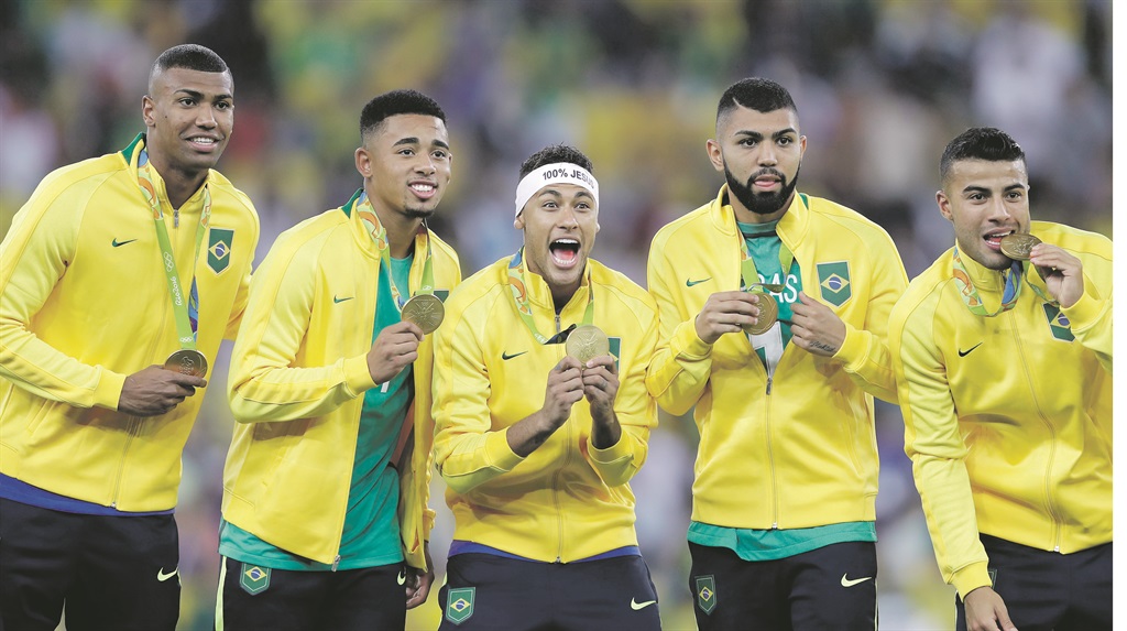 Members of Brazil’s football team celebrate after receiving their Olympic gold medals.  Picture: Andre Penner/AP 