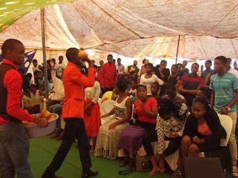 A pastor with rocks in his hands throwing congregants as he claim that God instructed him to do that so that they get healed.