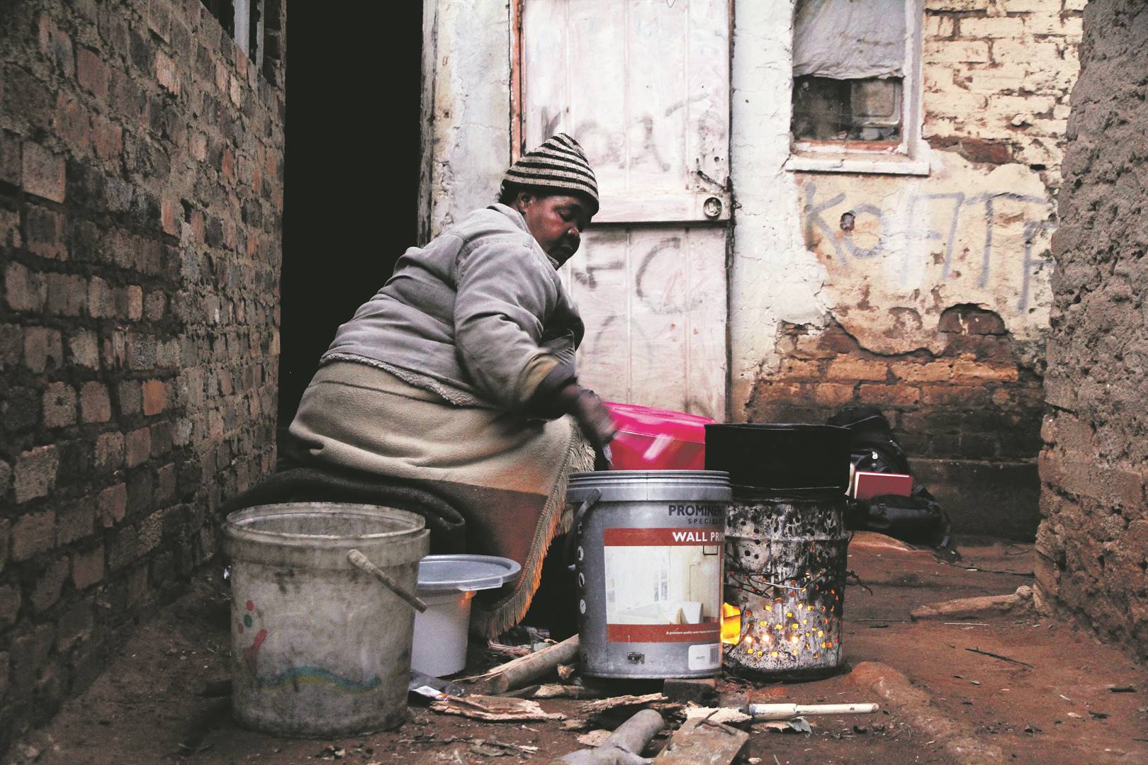  A woman makes amagwinya (fat cakes) at her residence in Vlakplaas, an informal settlement located in the heart of Vosloorus in Ekurhuleni. She started selling amagwinya to feed herself and her children after she lost her job when her employer relocated to another province. She is one of millions of South Africans who live below the poverty line. Photo: Rosetta Msimango