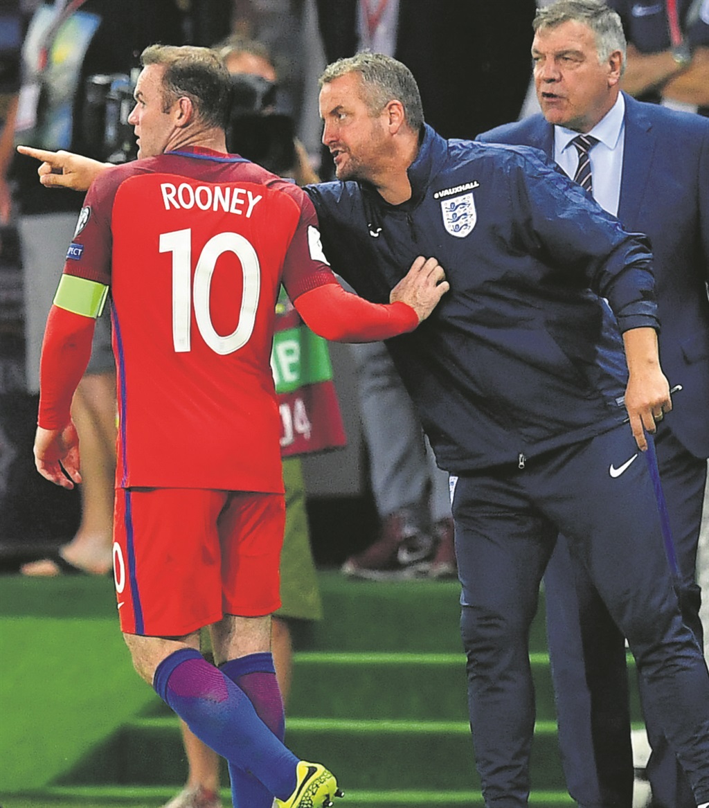 England captain Wayne Rooney takes instructions from head coach Sam Allardyce and goalkeeper coach Martyn Margetson during their match against Slovakia.  Photo by Getty Images 