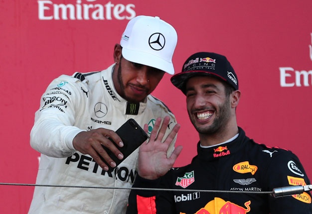 <b> "I GOT YOU LEWIS!" </b> Japanese Grand Prix winner Lewis Hamilton takes a selfie with Daniel Ricciardo on the podium at Suzuka. Image: AFP / Behrouz Mehri
