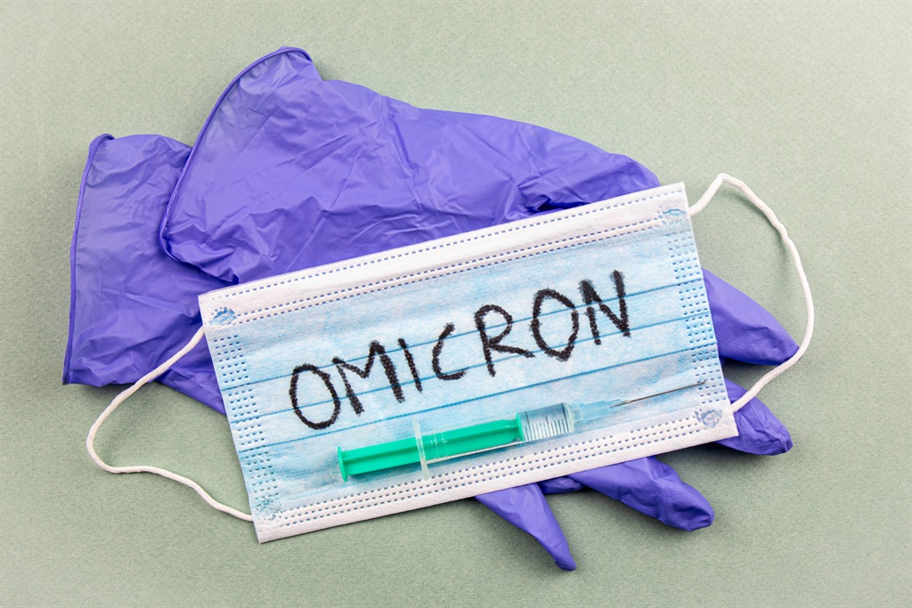 New Coronavirus Covid-19 mutation Omicron concept. Medical mask, syringe and text with letters Omicron.