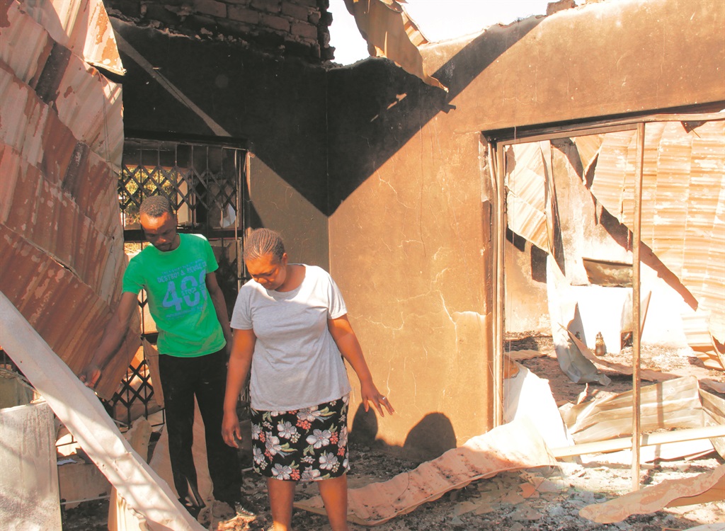 Khippy and Baboneng Nedzinwani look at the remains of their 11-roomed house which was struck by vutha on Tuesday.                                Photo by Armando Chikhudo 