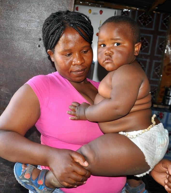 Mapaseka Semenyane can’t carry her 16-month-old son, Lucky, on her back because he’s too heavy.Photo by Kabelo Tlhabanelo