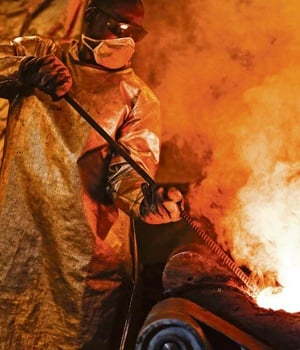 A mine worker stirs molten gold in a furnace before casting. T
ransfer pricing and profit 
shifting by multinationals inside and outside SA compromises empowerment partners, workers, communities and the country’s economy 