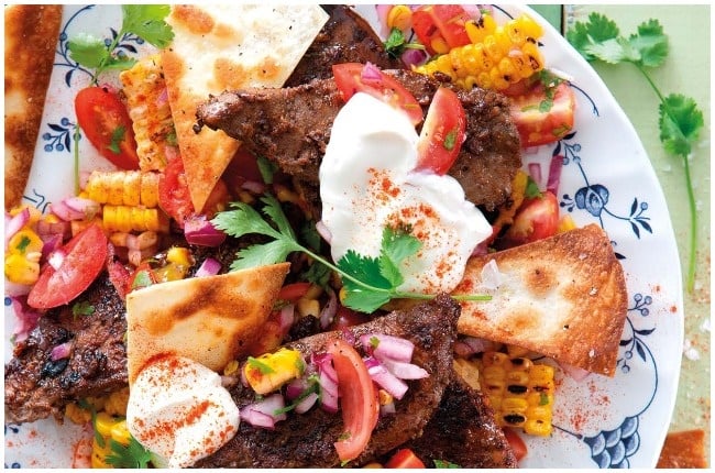 Spicy lamb liver with tomato and corn salad and sour cream.