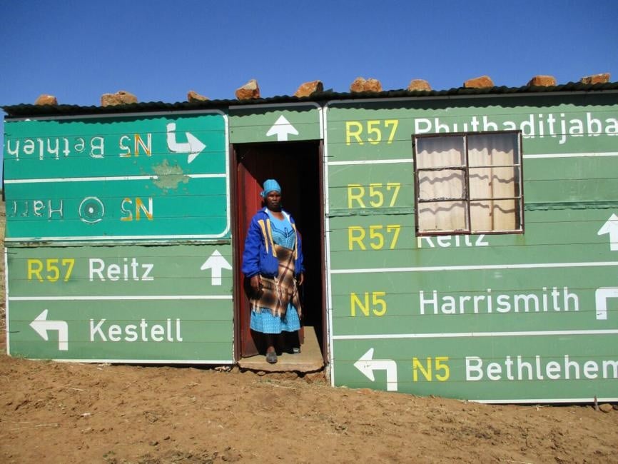 Malefa Makhubo stands at the door of the church in Makgolokoeng kasi. 
Photo by Ishmael Ntholeng