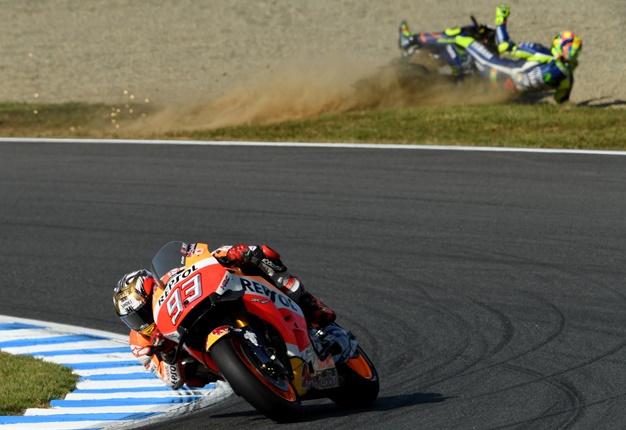 <b> DRAMA-FILLED RACE: </b> Marc Marquez (front) takes a corner as Yamaha rider Valentino Rossi (top) crashes during the MotoGP race at the Japanese Grand Prix. <i> Image: AFP / Toshifumu Kitamura </i>