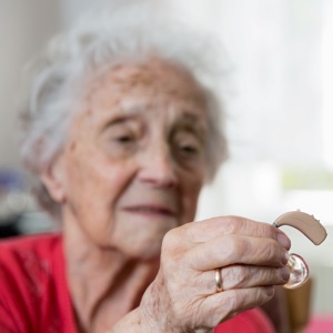 Senior with hearing aid – iStock