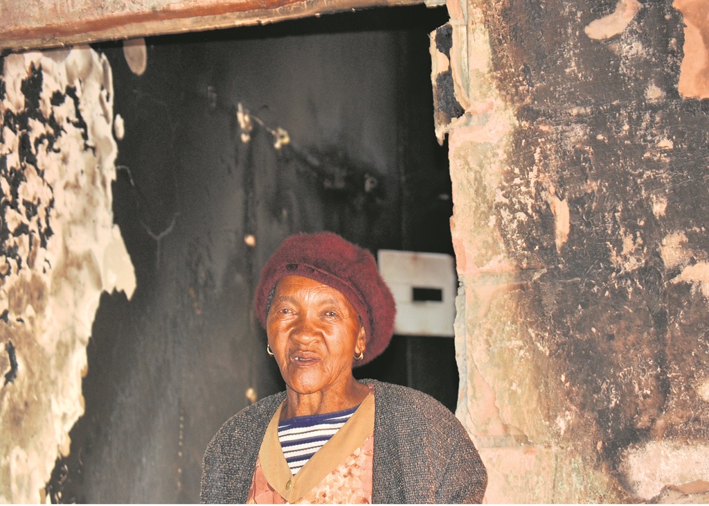 Ellen Goodman standing in her burnt house in Skierlik section in Bekkersdal, west of Joburg.       Photo by Sammy Moretsi 