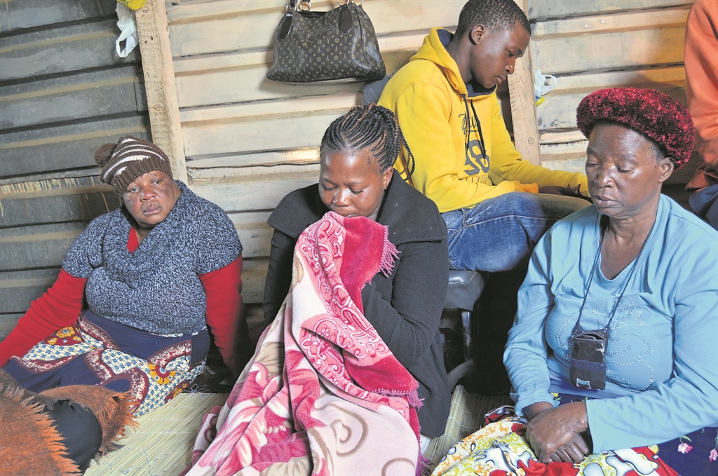 Front, from left: Monica Vilakazi, Luwisa Khosa and Ester Simelani are mourning the deaths of Alfred Dibane (32), Marios Dibane (31) and William Sumbani (32), who were allegedly hacked and stoned to death by angry community members in Vlakfontein.                 Photo by Everson Luhanga 