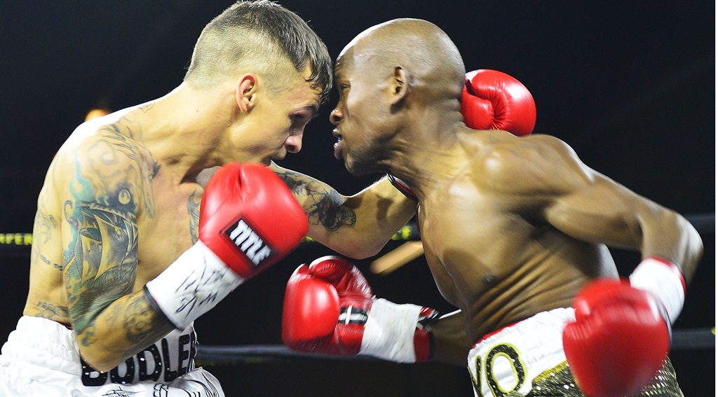 Hekkie Budler (left) and Siyabonga Siyo slug it out at Emperors Palace for the WBA Pan African junior flyweight title.  Photo by Themba Mkofane 