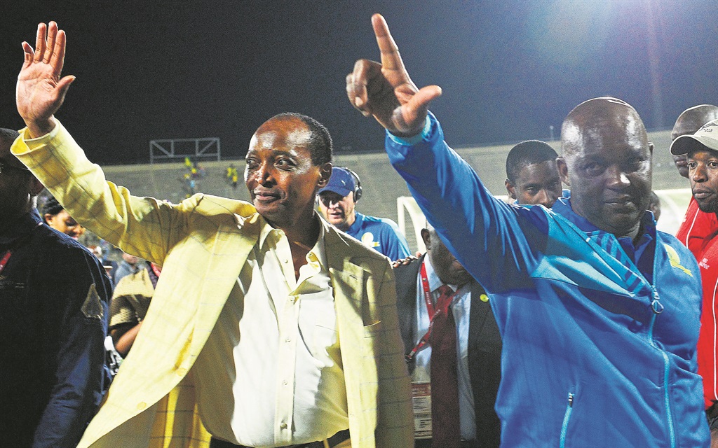 Mamelodi Sundowns boss Patrice Motsepe (left) and coach Pitso Mosimane salute their supporters after knocking Zesco United out of the Caf Champions League on Saturday. Photo by Themba Makofane 