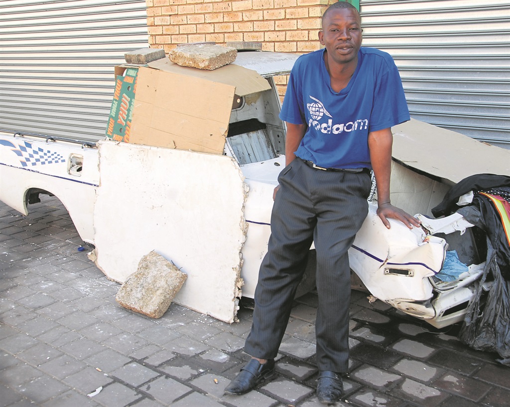 Frans Biya (42) washes his clothes outside his 1400 bakkie he has turned into his home.        Photo by Samson Ratswana 