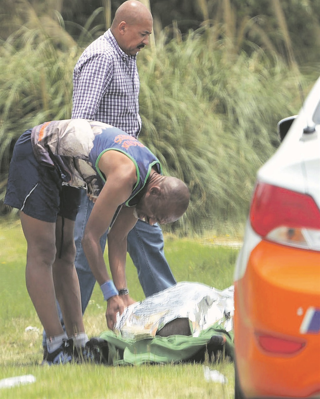 A runner covers the body of Hendrik Matthys.    Photo by     Trevor   Kunene 