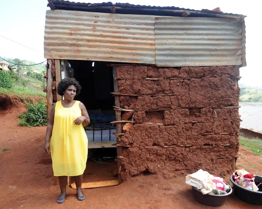 Heartbroken Nompumelelo Zulu-Khumalo stands outside her mud house after her husband kicked her out and married another woman on Our Perfect Wedding. Photos by Jabulani Langa