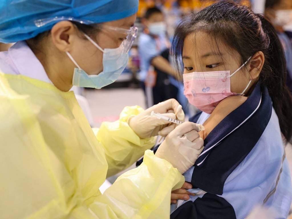 This image shows a child receiving a Covid-19 coronavirus vaccine in Xiamen, in China's eastern Fujian province.
