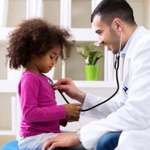 Doctor diagnosing young patient – iStock
