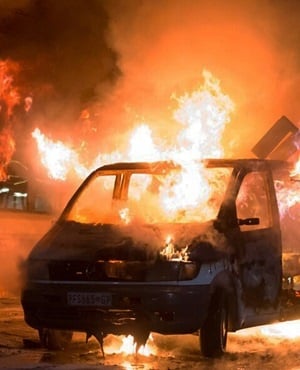 A car burns outside a nightclub near the University of the Witwatersrand. (Yeshiel Panchia, AP)
