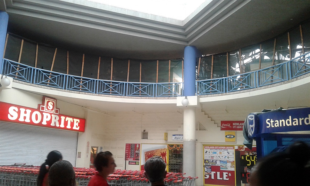 Shoprite customers waiting outside the store as it was closed due to the top building structure falls at Newlands East in Durban. Picture: Jabulani Langa 