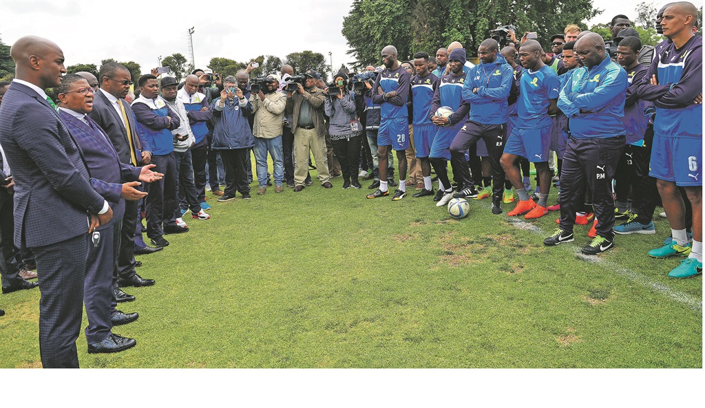 Sport Minister Fikile Mbalula (second from left) addresses the Mamelodi Sundowns players in Chloorkop yesterday as the media captures the moment.  Photo by Themba Makofane 