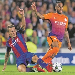 Barcelona’s Lucas Digne tries to block Raheem Sterling of Manchester City. (Alex Caparros, Getty Images)