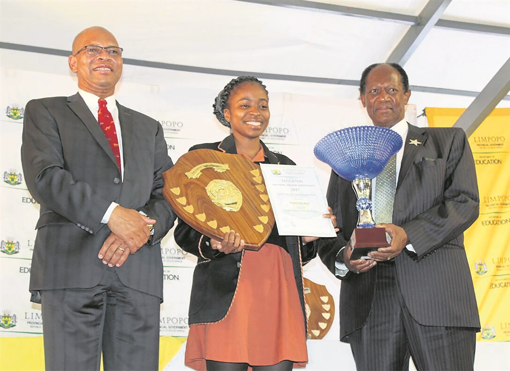 Anza Tshipetane received an award from Limpopo Premier Stan Mathabatha and the ZCC’s Bishop Barnabas Lekganyane.    Photo by Phuti Raletjena