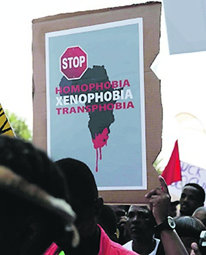 STOP A poster (left) displayed during a march against xenophobia in Johannesburg in 2015. (Picture: Iranti-org)