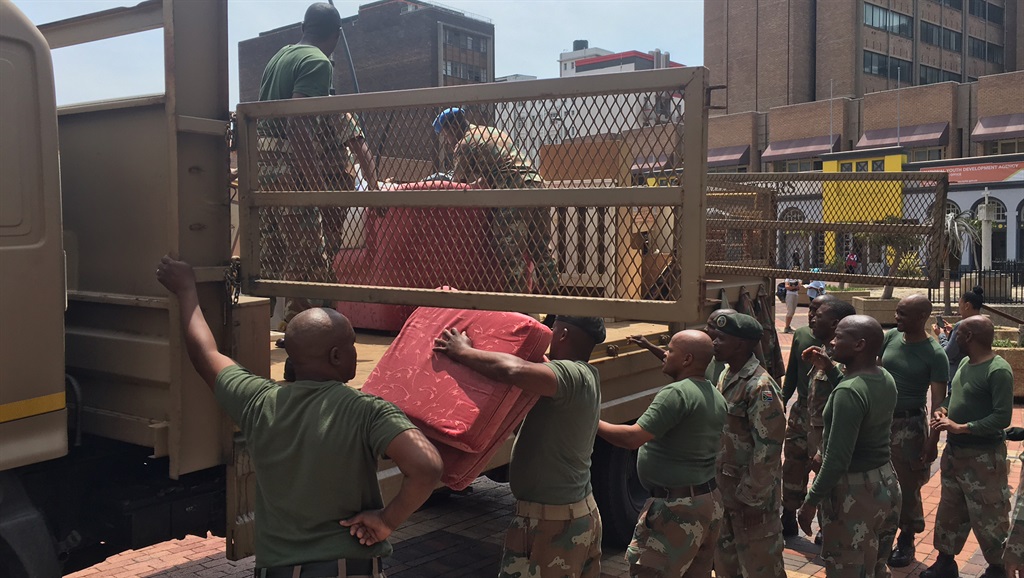 SANDF officials dumping five truckloads of furniture at City Hall. Picture: Nosipiwo Manona 