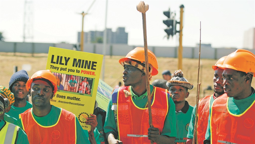 COMPOMISE Association of Mineworkers and Construction Union members protest in August as three mine workers’ bodies remain trapped underground at the Lily Gold Mine in Barberton, Mpumalanga. This week, the union successfully struck wage deals with major platinum mines, averting strike action. Picture: Gallo Images 