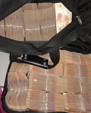 Some of the cash that was confiscated at Elton Bernard Abrahams' house. (Hawks)