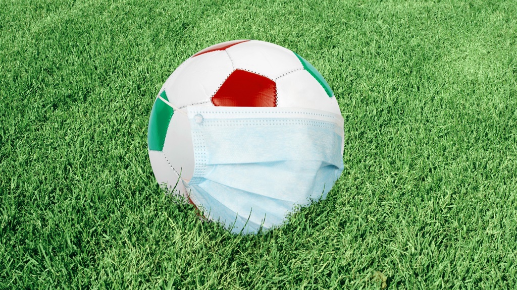 Soccer ball in italian colors with mask on green f